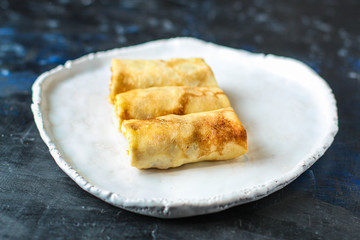 thin pancakes or crepes stuffed chicken meat and vegetables (hen or turkey) menu concept background. top view. copy spaces