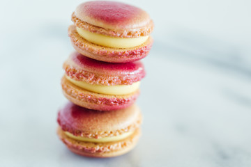 Assorted French macarons stacked on top of one another