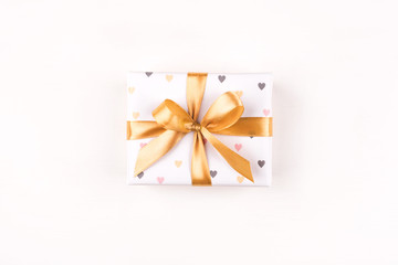 One gift boxe with bow and on a white background. Flat lay composition. Birthday, christmas, wedding or another holiday concept.