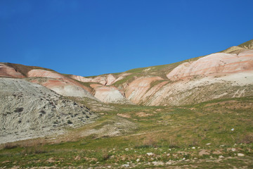 Red mountains in Xizi, Azerbaijan. Colorful hills . olorful geological formations . Red striped hills, rainbow mountains . View of the beautiful striped red mountain .