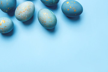 Easter frame of eggs painted in blue color. Flat lay, top view.