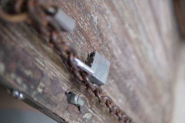 padlocks and chains hang from an old antique door