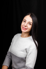 Portrait of serious beautiful female with black hair, has minimal makeup, looks calmly at camera,...