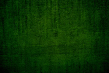 Texture of dark green surface with dimming. Beautiful dark green color for screensavers
