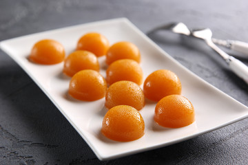 The concept of French cuisine. Fruit jelly on a light plate with forks. Background image, copy space