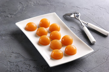 The concept of French cuisine. Fruit jelly on a light plate with forks. Background image, copy space