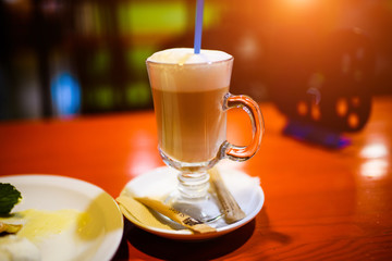 cup of tasty coffee, on wooden table background