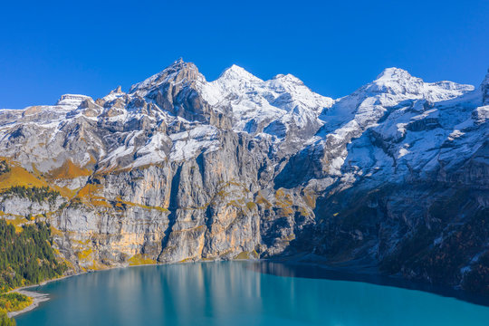 Aerial view on Lake Oeschinen with Blumlisalp mountain range, Kandersteg, Berner Oberland, Switzerland - Powered by Adobe