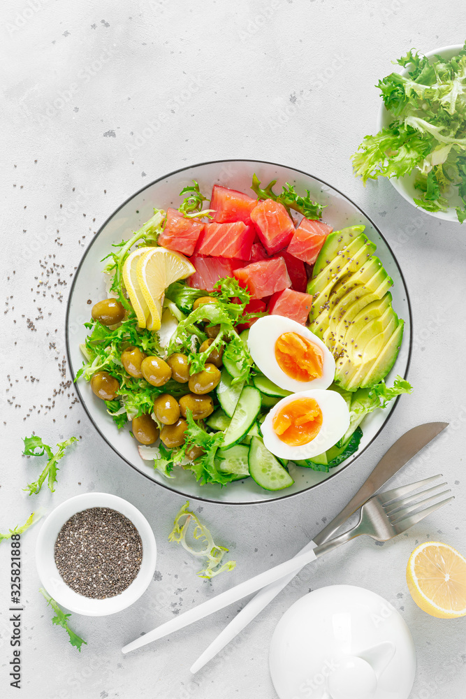 Wall mural ketogenic, keto or paleo diet lunch bowl with salted salmon fish, lemon, avocado, olives, boiled egg