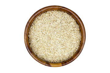 Uncooked brown rice in a wooden bowl on white background