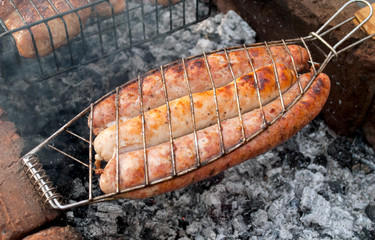 Barbecue grill with grilled sausages on charcoal