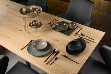 chef preparing food in the kitchen, beautiful tableware on a wooden table