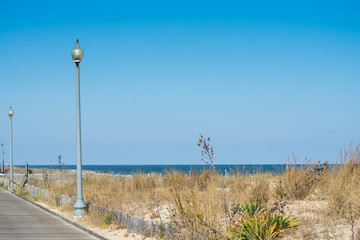 A view of the beach on a sunny day from deserted boardwalk in Rehoboth, Delaware