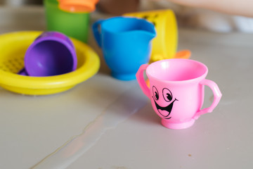 Toy cup with smile on gray table
