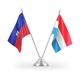 Luxembourg and Haiti table flags isolated on white 3D rendering