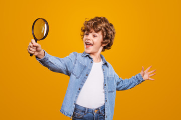 Curious boy with magnifying glass