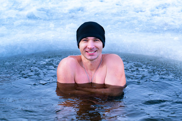 Hardening the body from diseases in cold water. Winter swimming in the ice hole.