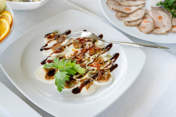 Boiled eggs with pumpkin seeds, dried tomatoes. Beautiful appetizer with sauce.