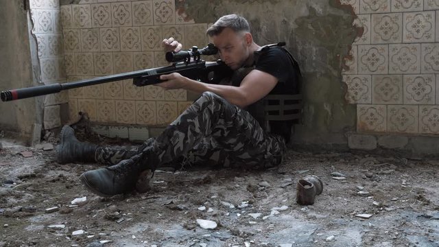 sniper is preparing a rifle. airsoft. 4k