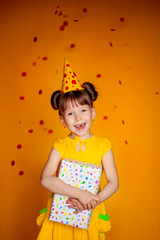 happy birthday happy girl with confetti on color yellow background