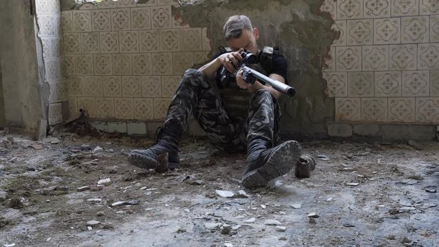 soldier sets up a sniper rifle. airsoft. 4k