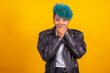 young modern brunette girl with curly blue hair of afro american ethnicity isolated on color background