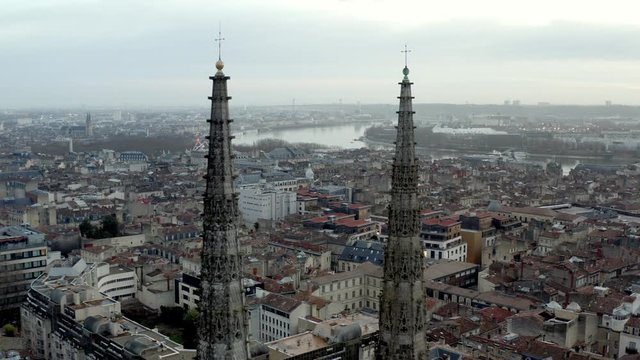 
Bordeaux Cathedral of St. Andrew in France fly-through spires with golden crosses on top, Aerial drone in-between shot