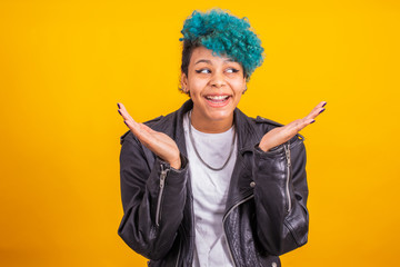 young modern brunette girl with curly blue hair of afro american ethnicity isolated on color background