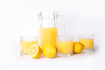 Jar of lemon juice with lemons isolated on a white background