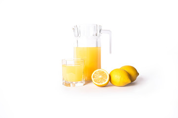 Jar of lemon juice with lemons isolated on a white background