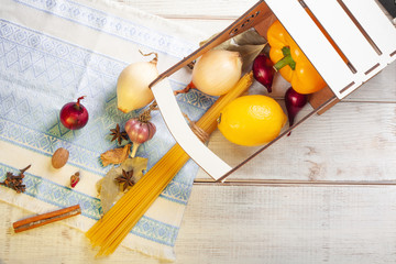 still life aromatic spices and pasta sprinkled on a white wooden table