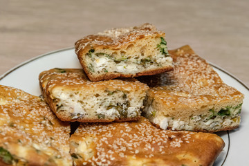 homemade pie with feta cheese and herbs close up
