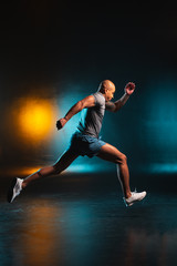 Fototapeta na wymiar Professional sportsman running fast indoors stock photo