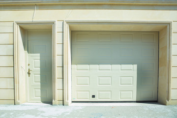 Fototapeta premium Shutter door or roller door and concrete floor outside .White Automatic shutters in a house . gates in the garage . Automatic Electric Roll-up Gate Or Push-up Door In Building Ground Floor .