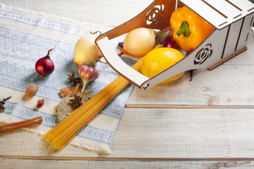 still life aromatic spices and pasta sprinkled on a white wooden table