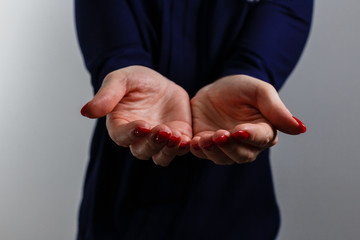 Woman's hands praying against a white background