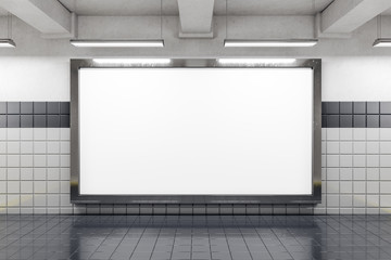 Front view of empty subway poster on white wall.