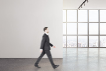 Fototapeta premium Businessman walking in modern interior
