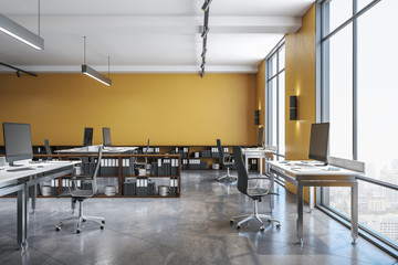 Computers in yellow office interior