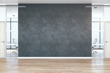 Modern empty office hall with blank black wall
