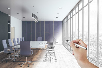 Hand with pen drawing conference office interior