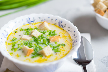 creamy potato soup with croutons and fresh herbs