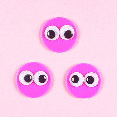Three strange characters with round faces and mad googly eyes in love, looks to each other. Valentines Day, close up googly eyes.