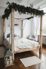 Spacious bedroom with bed against a wall. Bed with wooden canopy. Modern home interior design concept. scandinavian style © paralisart