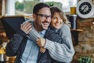 Portrait of embraced couple in the kitchen.
