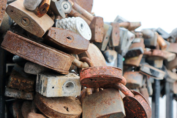 old rusty love locks on the bridge railing close up