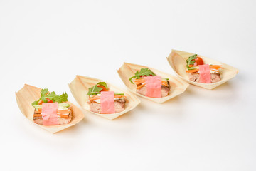 Canape dish with meat, cheese, cucumber, carrots and herbs. Concept of catering, hospitality and lifestyle