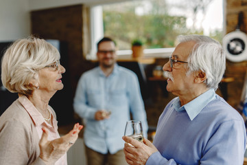 Senior couple discussing while standing in the kitchen.