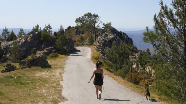 Woman walking with dog in Arouca Serra da Freita mountain, Portugal