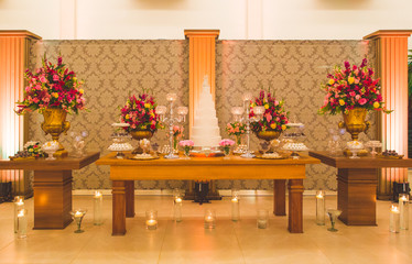 cake table decorated with flowers for wedding